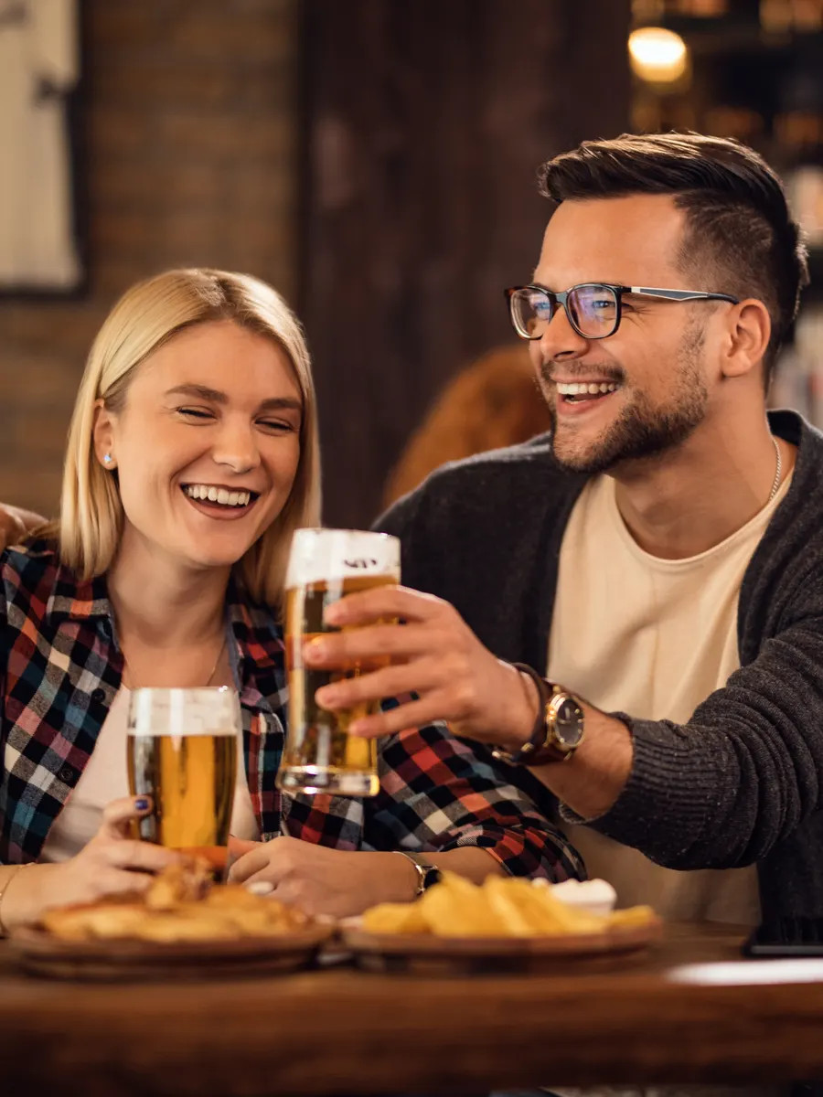 Una pareja brindando en un bar